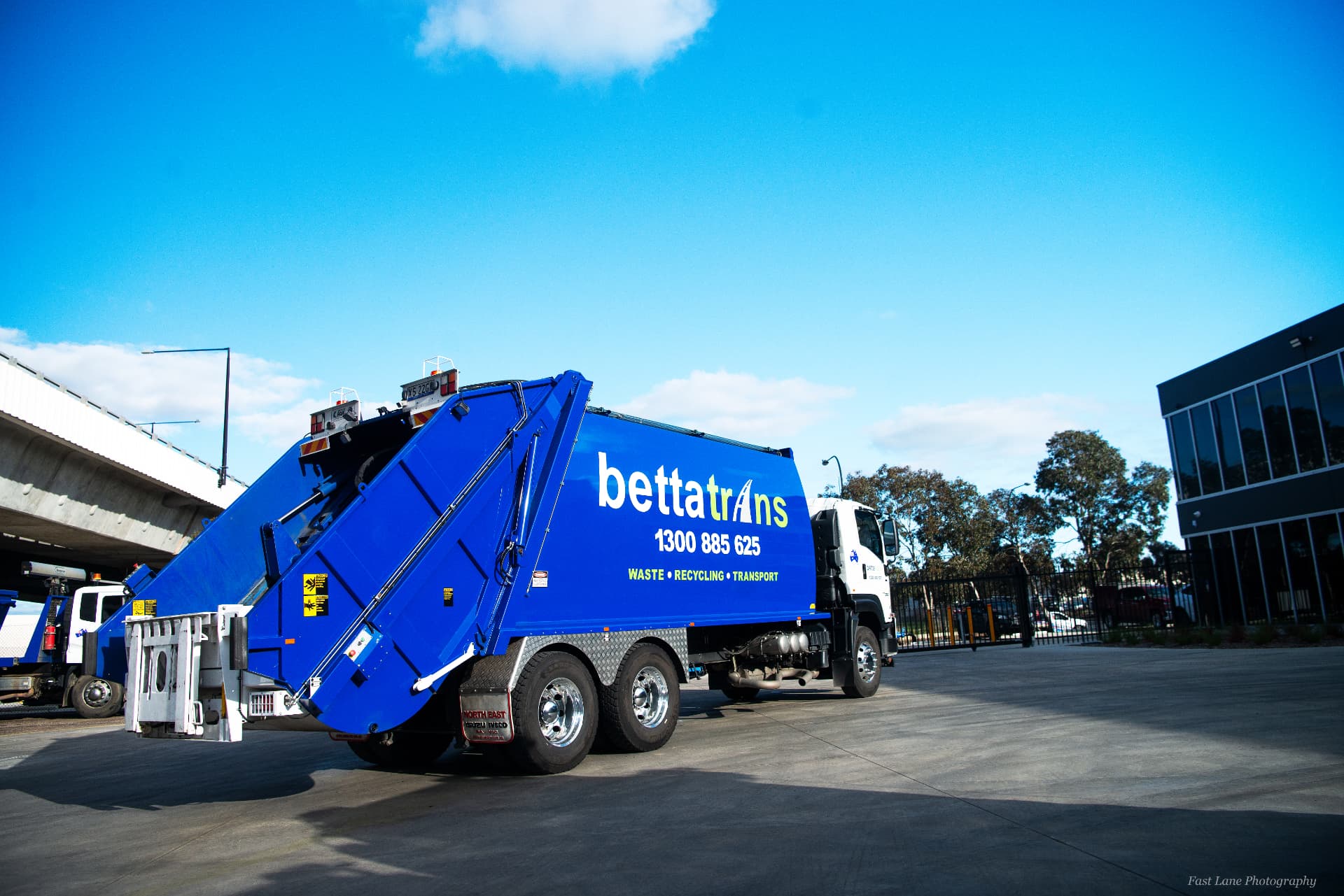 Bettatrans rearlift truck collecting commercial bins